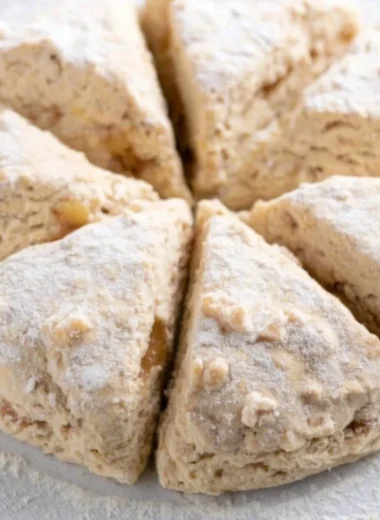 Delicious soft spiced apple scones on a wooden table