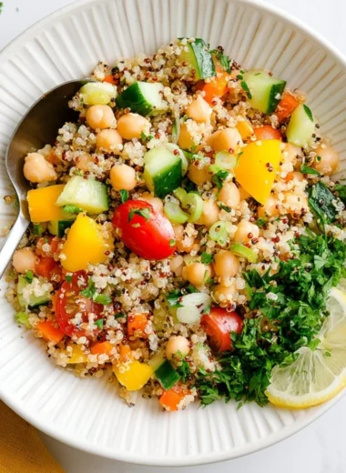 A vibrant Lemon Quinoa & Chickpea Salad served in a bowl, showcasing healthy ingredients.