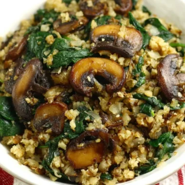 Mushroom Spinach Cauliflower Rice served in a bowl with fresh ingredients