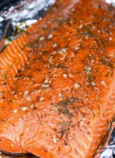 Smoked salmon dish garnished with herbs and lemon slices