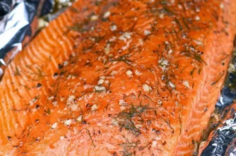 Smoked salmon dish garnished with herbs and lemon slices