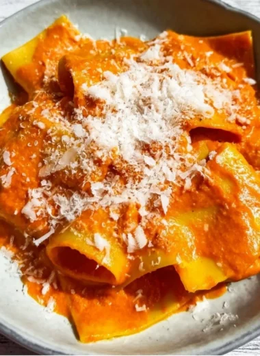 Delicious vodka pasta dish garnished with fresh basil and grated cheese