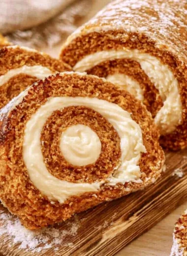 Delicious Copycat Libby's Pumpkin Roll dessert on a rustic wooden table