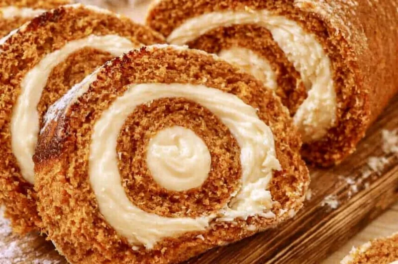 Delicious Copycat Libby's Pumpkin Roll dessert on a rustic wooden table