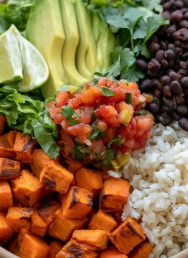 Cozy black bean and sweet potato burrito bowls garnished and ready to serve.