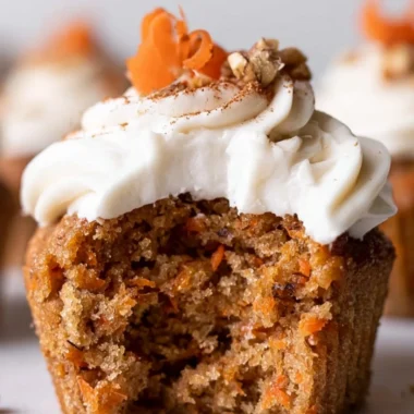 Cozy carrot cake cupcakes topped with cream cheese frosting