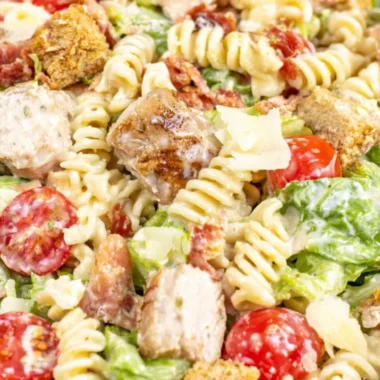 Cozy Chicken Caesar Pasta Salad with chicken, pasta, romaine, and Caesar dressing.