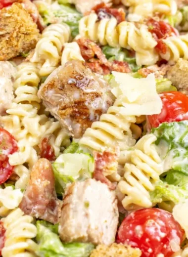 Cozy Chicken Caesar Pasta Salad with chicken, pasta, romaine, and Caesar dressing.