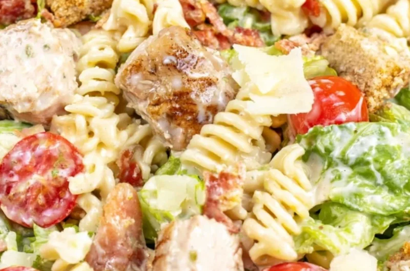 Cozy Chicken Caesar Pasta Salad with chicken, pasta, romaine, and Caesar dressing.