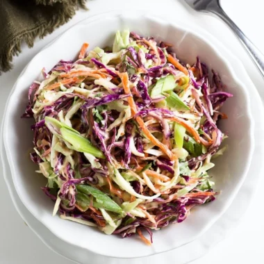 Cozy coleslaw served alongside pulled pork sandwiches