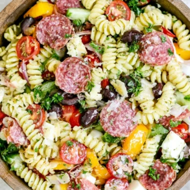 Cozy Italian Pasta Salad with tomatoes, olives, and fresh basil in a bowl