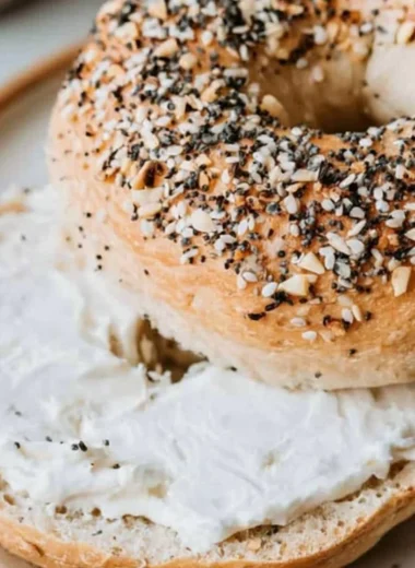 Freshly baked cozy sourdough bagels on a wooden table.