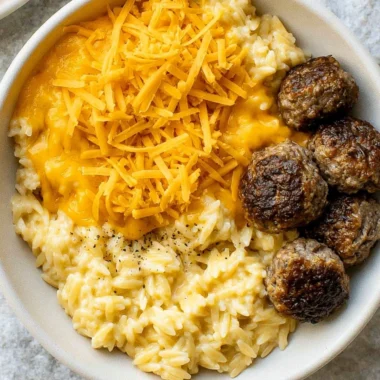 Creamy cheesy orzo pasta dish garnished with herbs