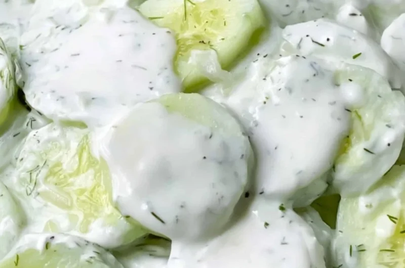 Creamy cucumber salad with fresh ingredients in a bowl ready to serve.