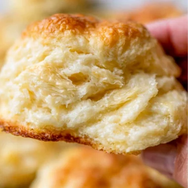Freshly baked fluffy homemade biscuits served on a plate