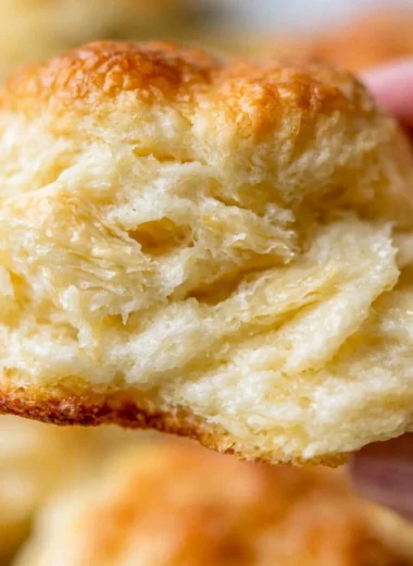 Freshly baked fluffy homemade biscuits served on a plate