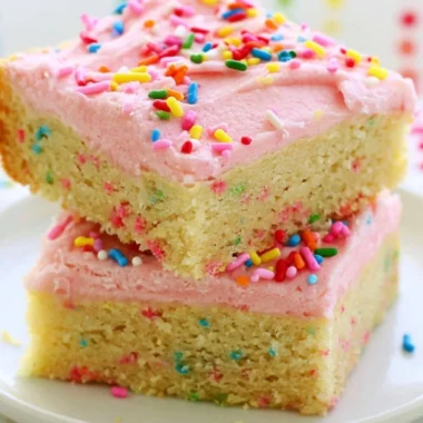 Delicious Funfetti sugar cookie bars topped with colorful sprinkles.