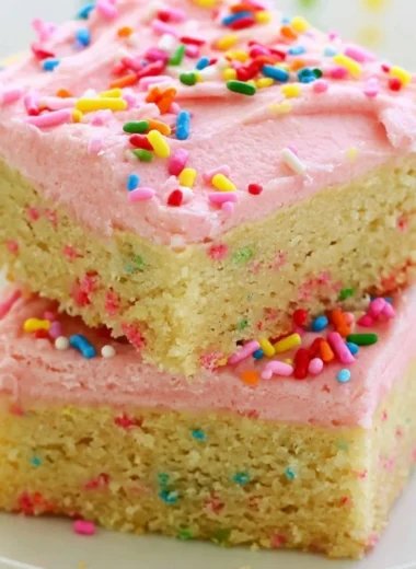 Delicious Funfetti sugar cookie bars topped with colorful sprinkles.