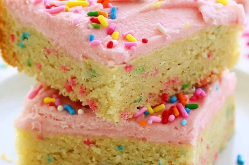 Delicious Funfetti sugar cookie bars topped with colorful sprinkles.