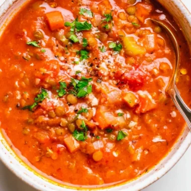 Bowl of Mediterranean Lentil Soup with fresh vegetables and herbs