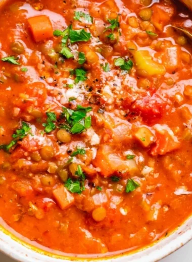 Bowl of Mediterranean Lentil Soup with fresh vegetables and herbs