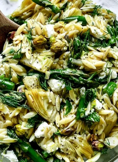 Delicious orzo salad with feta cheese and asparagus in a vibrant bowl