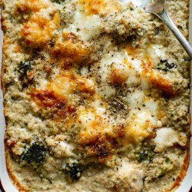 Cheesy quinoa bake with chicken and broccoli in a baking dish