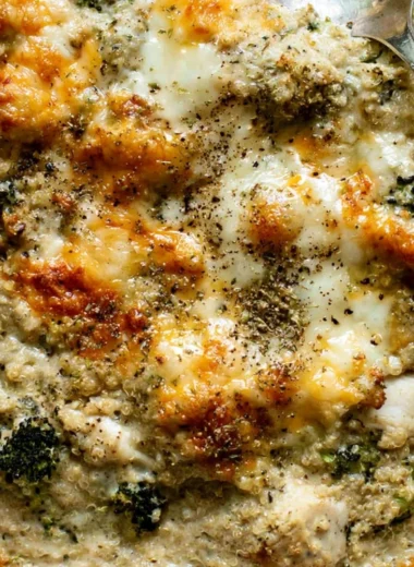 Cheesy quinoa bake with chicken and broccoli in a baking dish