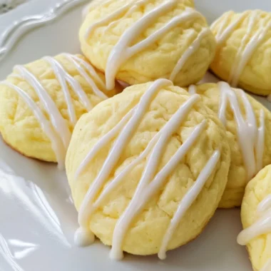 Soft lemon cheesecake cookies on a plate with a lemon slice