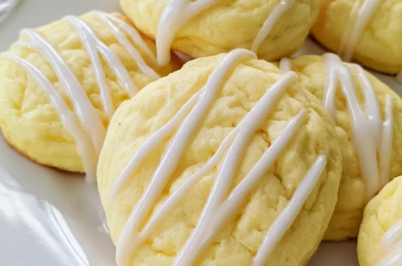 Soft lemon cheesecake cookies on a plate with a lemon slice